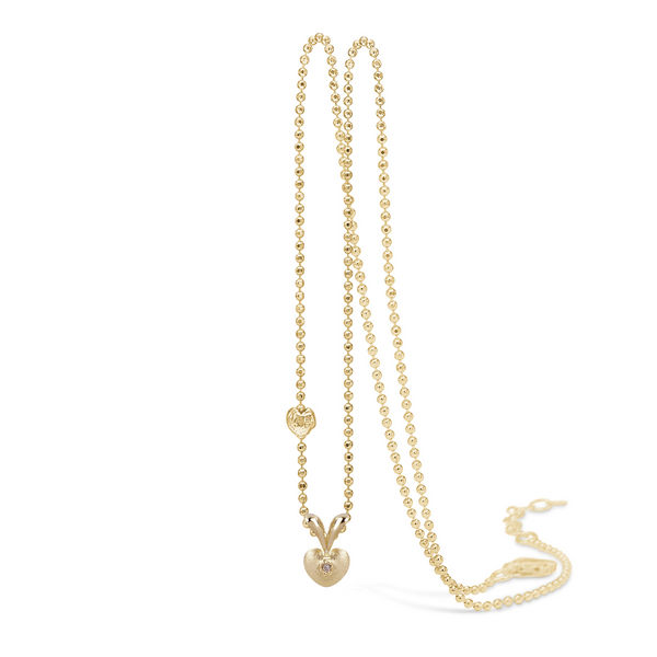 14 kt 'Conjure' gold necklace with a diamond in a small heart