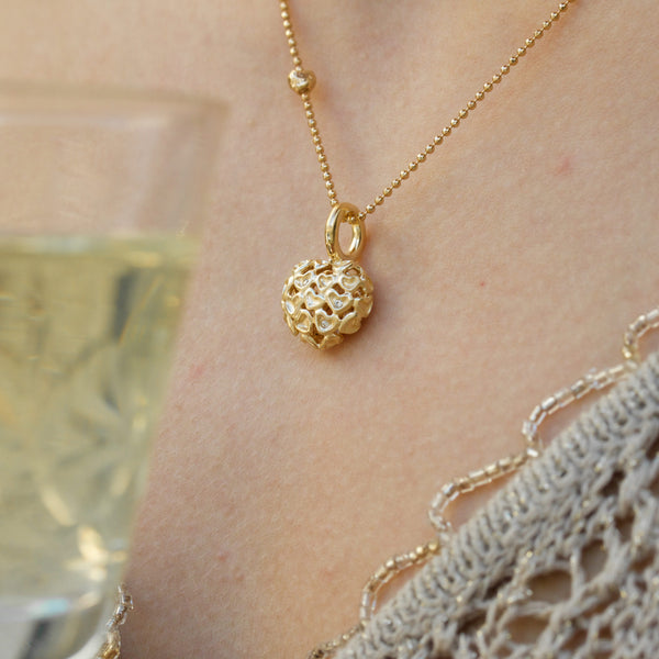Gold-plated sterling silver necklace with heart pendant of matte hearts and cubic zirconia