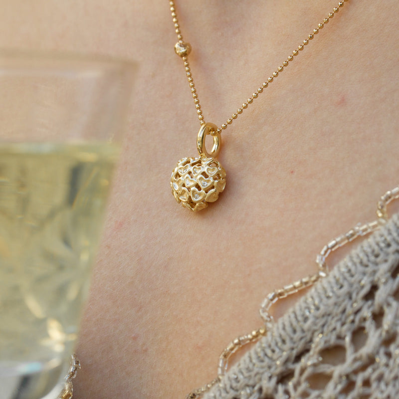 Gold-plated sterling silver necklace with heart pendant of matte hearts and cubic zirconia