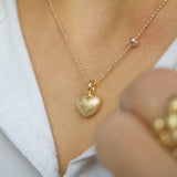 14 kt gold necklace with a heart and three diamonds