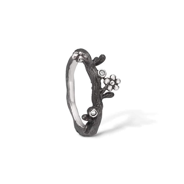 Oxidized sterling silver ring with branched flowers and cubic zirconia
