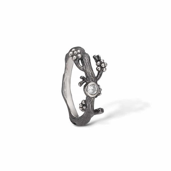 Oxidized sterling silver ring with branch flowers and a large cubic zirconia